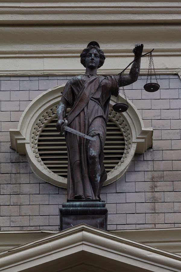 A figure of the allegorical Lady Justice above the entrance to the Scott County Courthouse in Georgetown, Kentucky