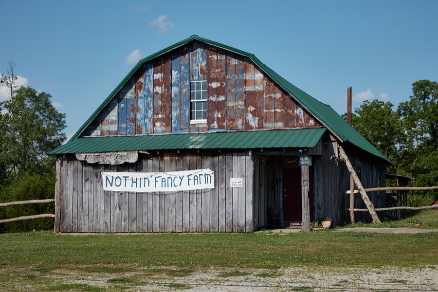 The "Nothin' Fancy Farm" sign, placed on a most ordinary barn, presumably by an owner who knows his property's limitations, near Richmond, Kentucky