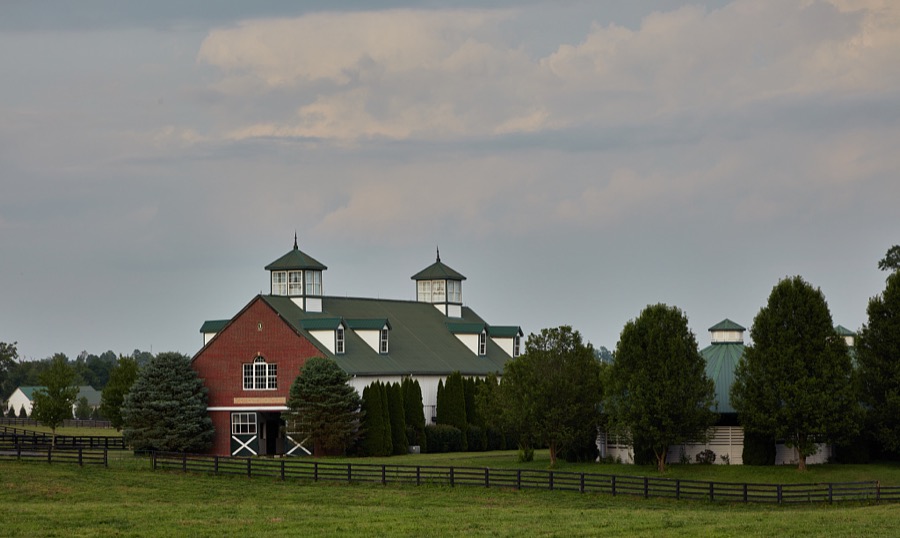 A classic Kentucky horse stable at Stonewall Farm, a thoroughbred racehorse breeding farm outside Versailles, Kentucky