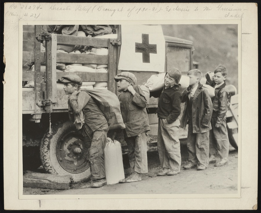 Going to eat hearty this evenin' " grinned these small boys, as they shouldered Red Cross rations up to Betsy Lane [i.e. Layne] camp, Floyd County, in the mountains of Kentucky. The Red Cross chapter took the supplies up by truck load, as the community is very isolated, and starvation threatened its inhabitants
