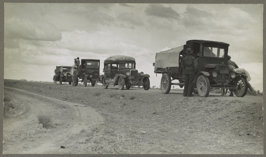 Three related drought refugee families stalled on the highway near Lordsburg, New Mexico. From farms near Claremore, Oklahoma. Have been working as migratory workers in Calfornia and Arizona, now trying to get to Roswell, New Mexico, for work chopping cotton. Have car trouble and pulled up alongside the highway. "Would go back to Oklahoma but can't get along there. Can't feed the kids on what they give you (relief budget) and ain't made a crop there you might say for five years. Only other work there is fifty cents a day wages and the farmers can't pay it anyways." One of these families has lost two babies since they left their home in Oklahoma. The children, seventeen months and three years, died in the county hospital at Shafter California, from typhoid fever, resulting from unsanitary conditions in a labor camp