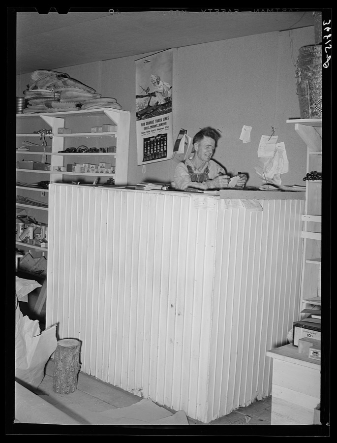 Mr. Craig works on his bills in the warehouse store. Pie Town, New Mexico