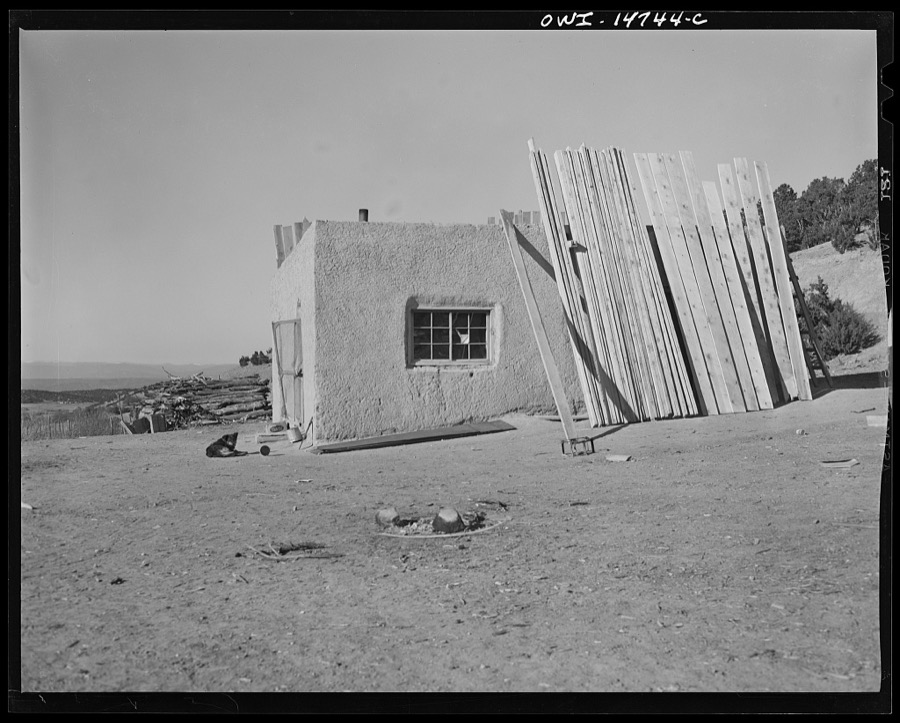 Ojo Sarco, New Mexico. Ojo Sarco Valley is scattered with villages which have grown up around one family. The land is re-divided until its owners are forced to go elsewhere to make cash, while their families remain at home. Lumber with which to build a pitched roof