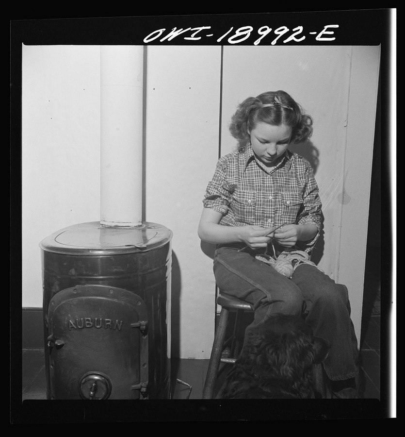 Moreno Valley, Colfax County, New Mexico. A rancher's daughter knitting during a poker party at George Turner's ranch