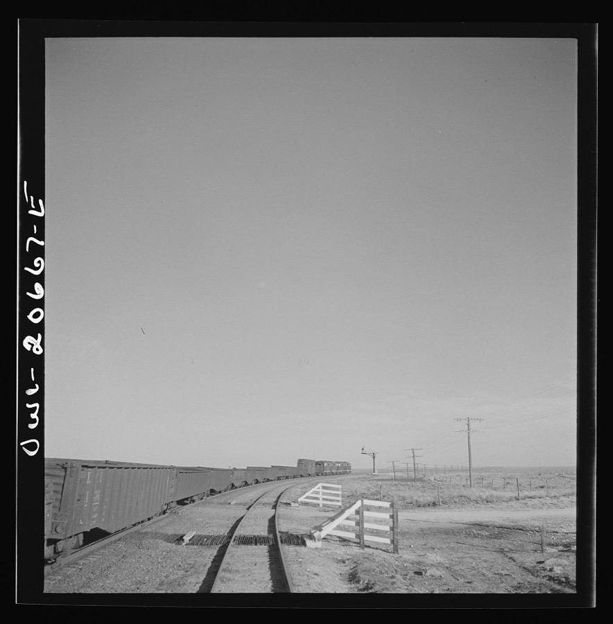 Buchanan, New Mexico. Passing an eastbound diesel freight train along the Atchison, Topeka, and Santa Fe Railroad between Clovis and Vaughn, New Mexico