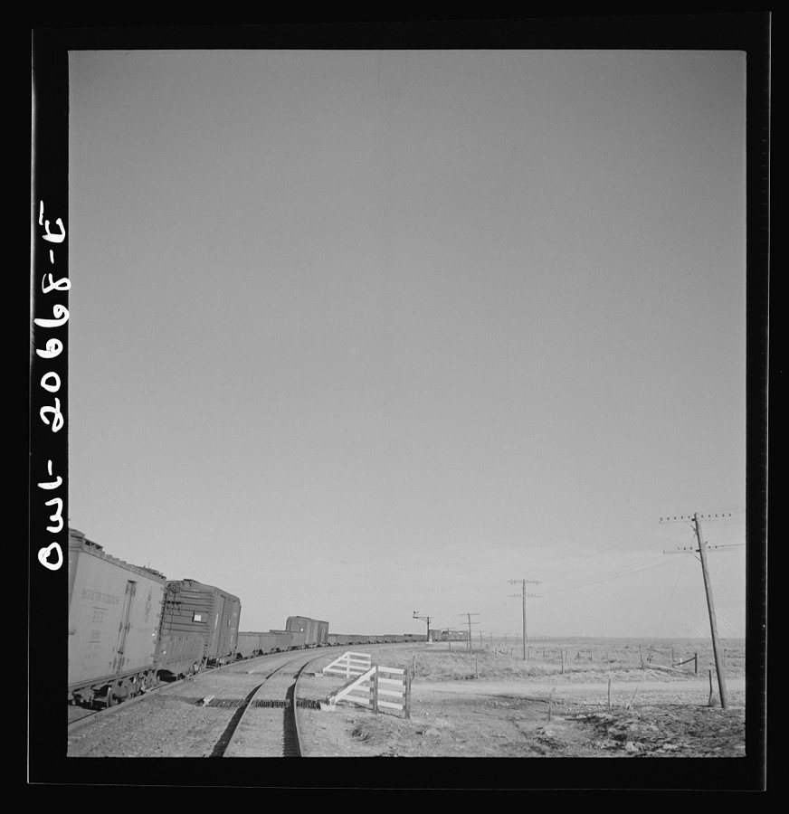 Buchanan, New Mexico. Passing an eastbound diesel freight train along the Atchison, Topeka, and Santa Fe Railroad between Clovis and Vaughn, New Mexico
