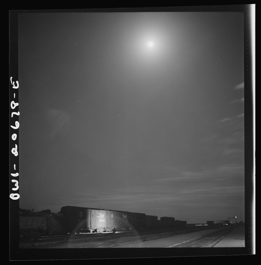 Vaughn, New Mexico. Train inspector at work in the Atchison, Topeka and Santa Fe Railroad yard, between Clovis and Vaughn, New Mexico