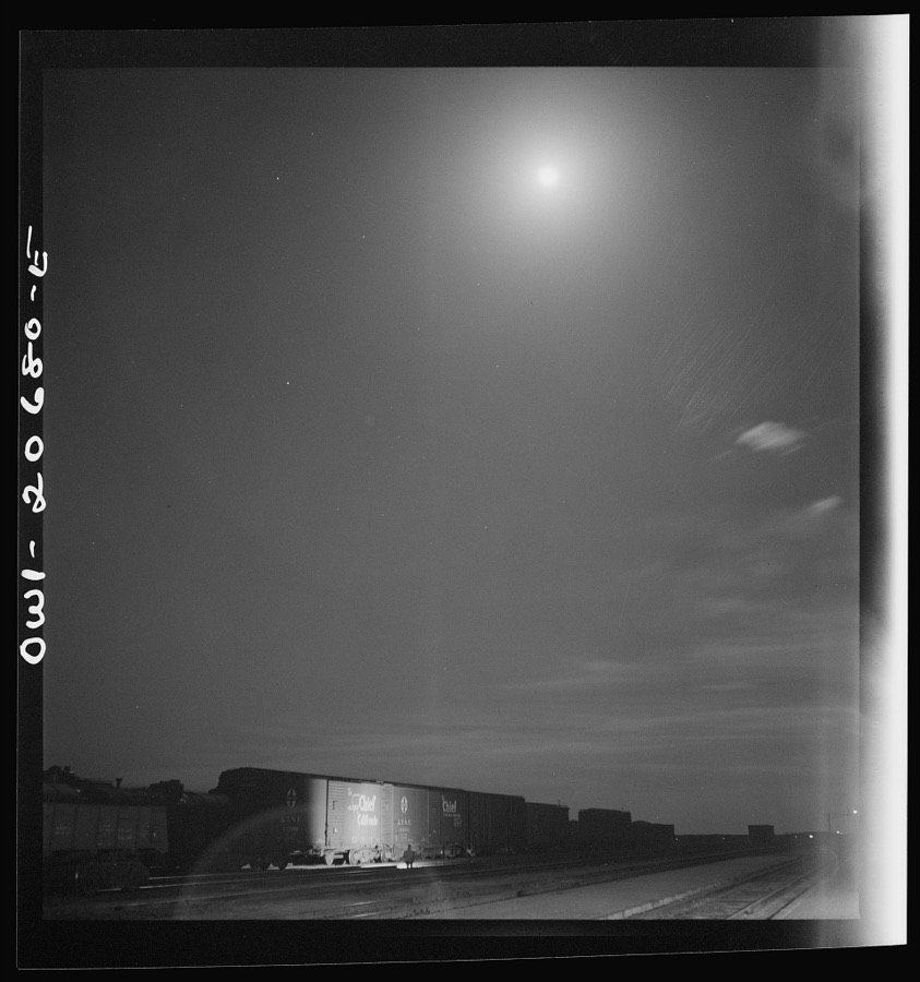 Vaughn, New Mexico. Train inspector at work in the Atchison, Topeka and Santa Fe Railroad yard, between Clovis and Vaughn, New Mexico