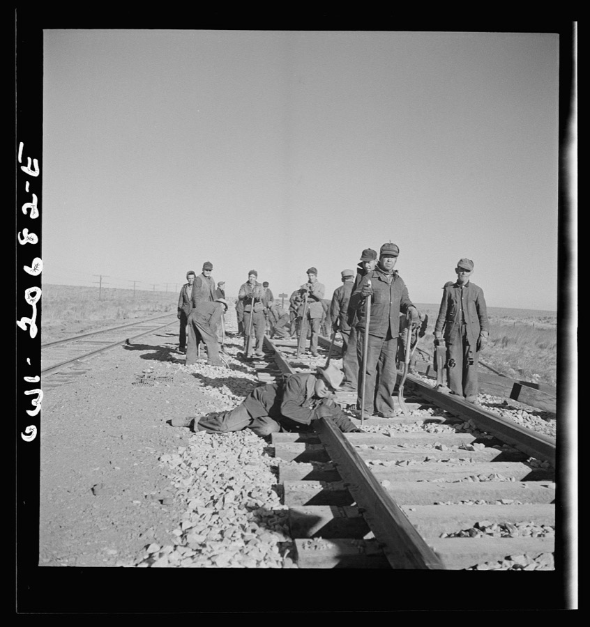 Iden, New Mexico. Section gang raising, surfacing and gauging the track in the Atchison, Topeka and Santa Fe Railroad between Clovis and Vaughn