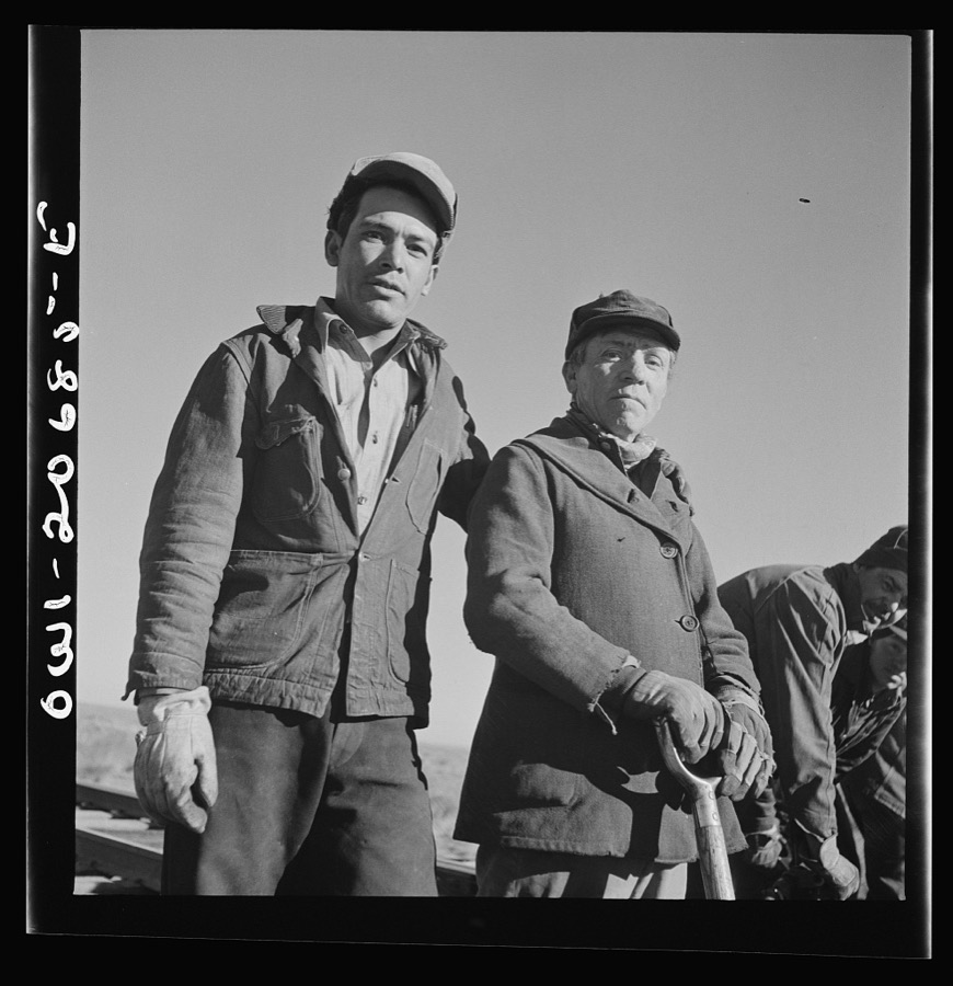 Iden, New Mexico. Joe Melende, left, and E. Argonne of Mountainair, New Mexico. Section workers on a job in the Atchison, Topeka and Santa Fe Railroad yard, between Clovis and Vaughn, New Mexico