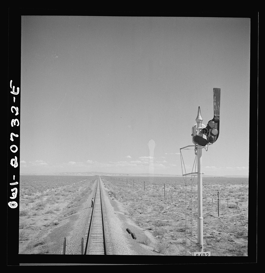 Willard, New Mexico. Flagman walks back to flag any oncoming trains his train stops for water between Vaughn and Belen, New Mexico on the Atchison, Topeka and Santa Fe Railroad