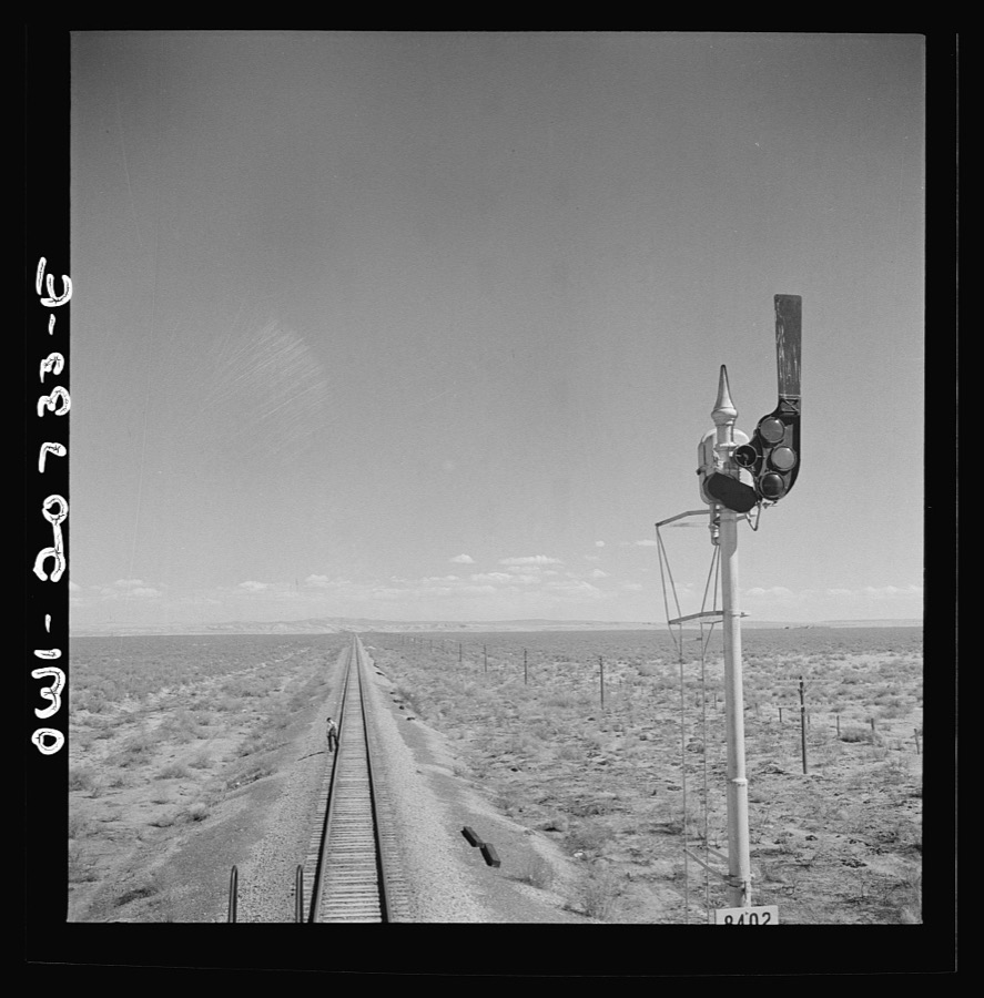Willard, New Mexico. Flagman walks back to flag any oncoming trains his train stops for water between Vaughn and Belen, New Mexico on the Atchison, Topeka and Santa Fe Railroad