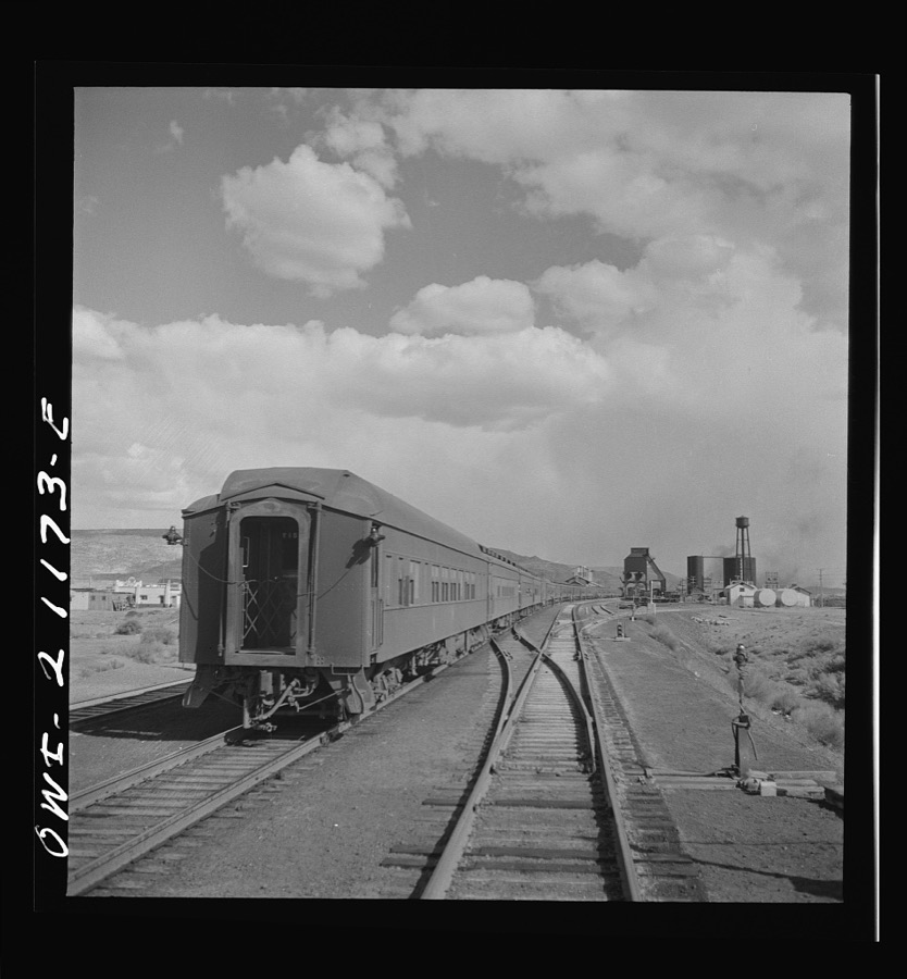 Grants, New Mexico. Passing a troop train stopping for coal and water on the Atchison, Topeka and Santa Fe Railroad between Belen and Gallup, New Mexico