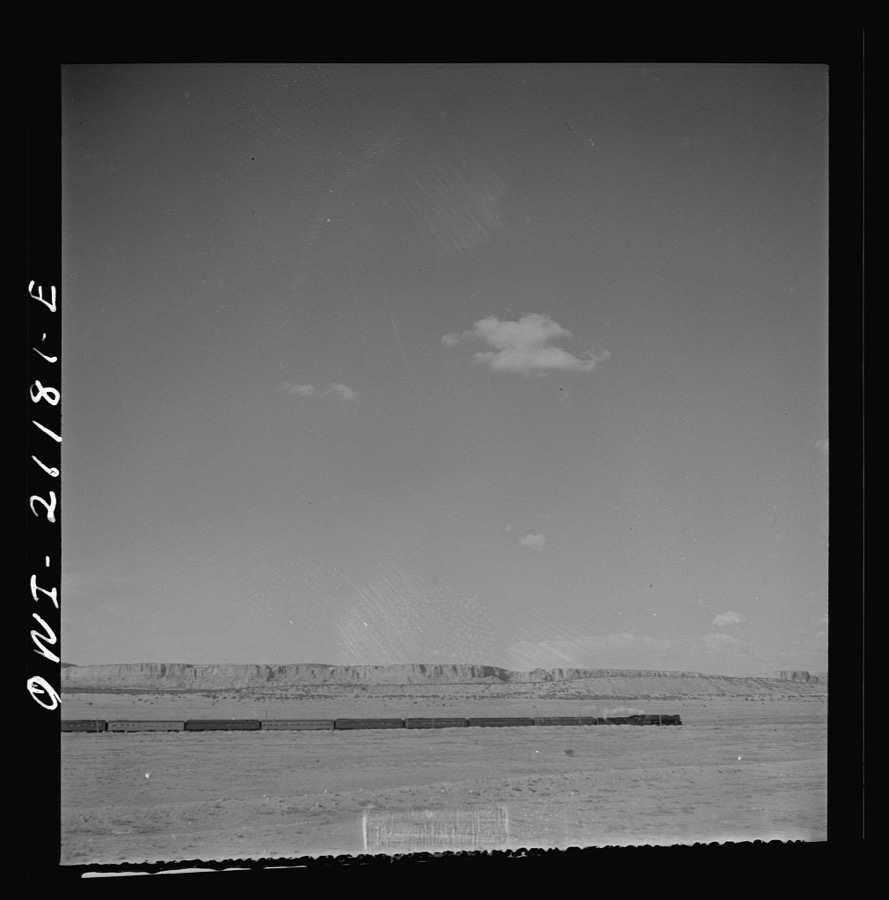 South Chaves (vicinity), New Mexico. On the Atchison, Topeka and Santa Fe Railroad between Belen and Gallup, New Mexico, passing an eastbound passenger train
