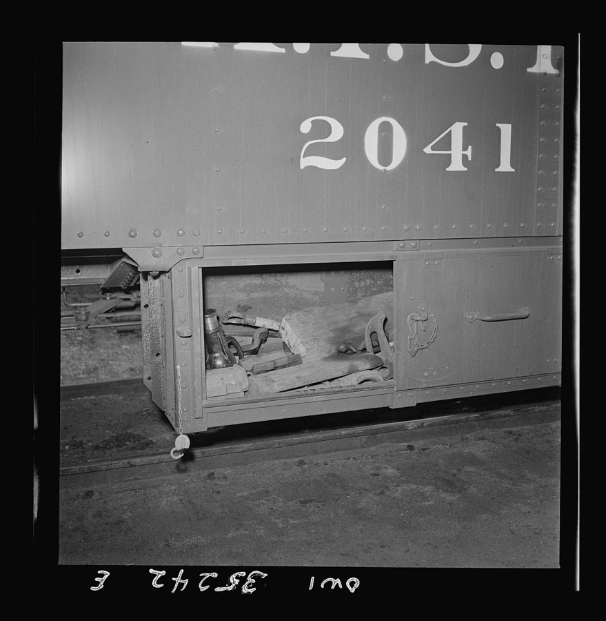 Clovis, New Mexico. Compartment in a new Atchison, Topeka and Santa Fe Railroad caboose containing a jack and other tools for making flight running repairs