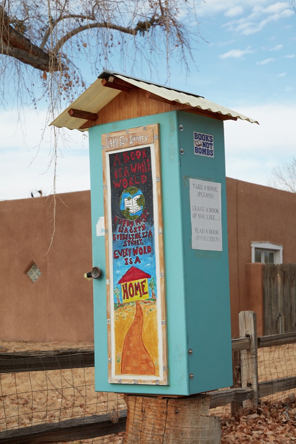 A Little Free Library with a message worth reading in Los Ranchos de Albuquerque (the Ranches of Albuquerque), which locals often abbreviate to simply "Los Ranchos," a northern suburb of the capital city of New Mexico where, indeed, many small horse farms can be found within neighborhoods of modest adobe structures