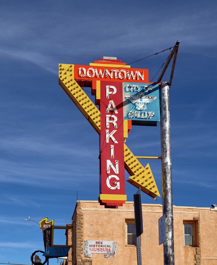 A motel-like neon sign for a downtown parking lot, entitled "Parking Lot," in Gallup, a small city near the Arizona border in far-western New Mexico