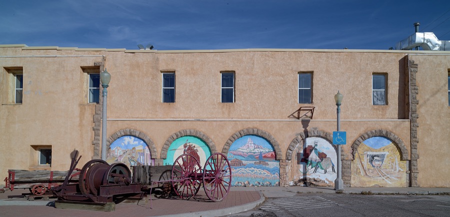 Small mural portals on a wall of the Rex Museum, once a brothel, later a grocery store, and now (as of 2021) a historical museum in Gallup, a small city near the Arizona border in far-western New Mexico