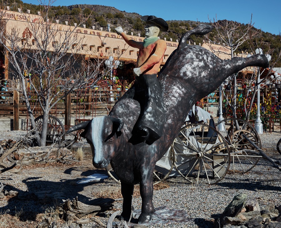 Colorful metal-art bull and rider displayed outside the Casa Cristal Pottery home-and-garden roadside store near Velarde in northern New Mexico