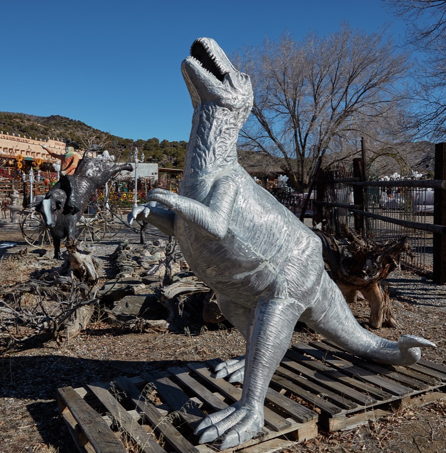 Metal-art dinosaur displayed outside the Casa Cristal Pottery home-and-garden roadside store near Velarde in northern New Mexico