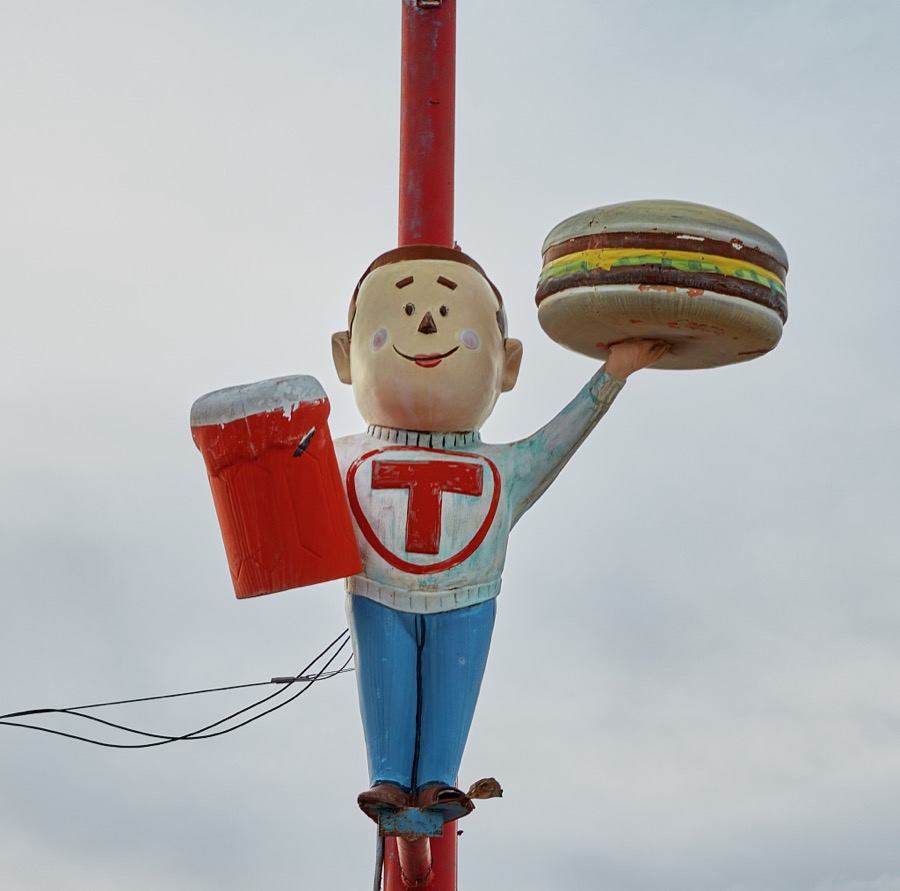 A fiberglass figure of a teenager, unnamed so far as one can tell, sports a college letterman's sweater emblazoned with an encircled letter T outside the Circle T drive-in restaurant in the central New Mexico town of Belen