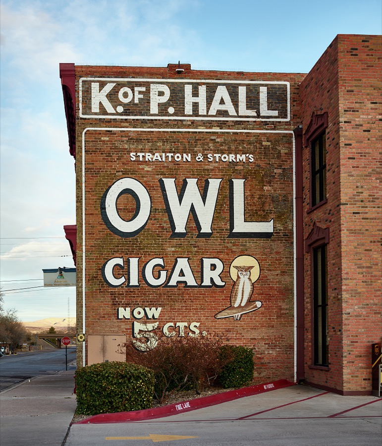A classic Owl Cigar advertising sign dominates a block of Socorro, a small city in central New Mexico