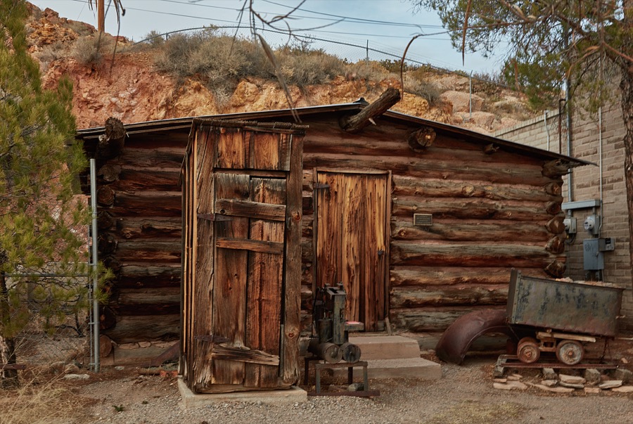 An old cabin and mine car at a rock-garden plaza outside the Geronimo Springs Museum and Sierra County Historical Society in Truth or Consequences, New Mexico