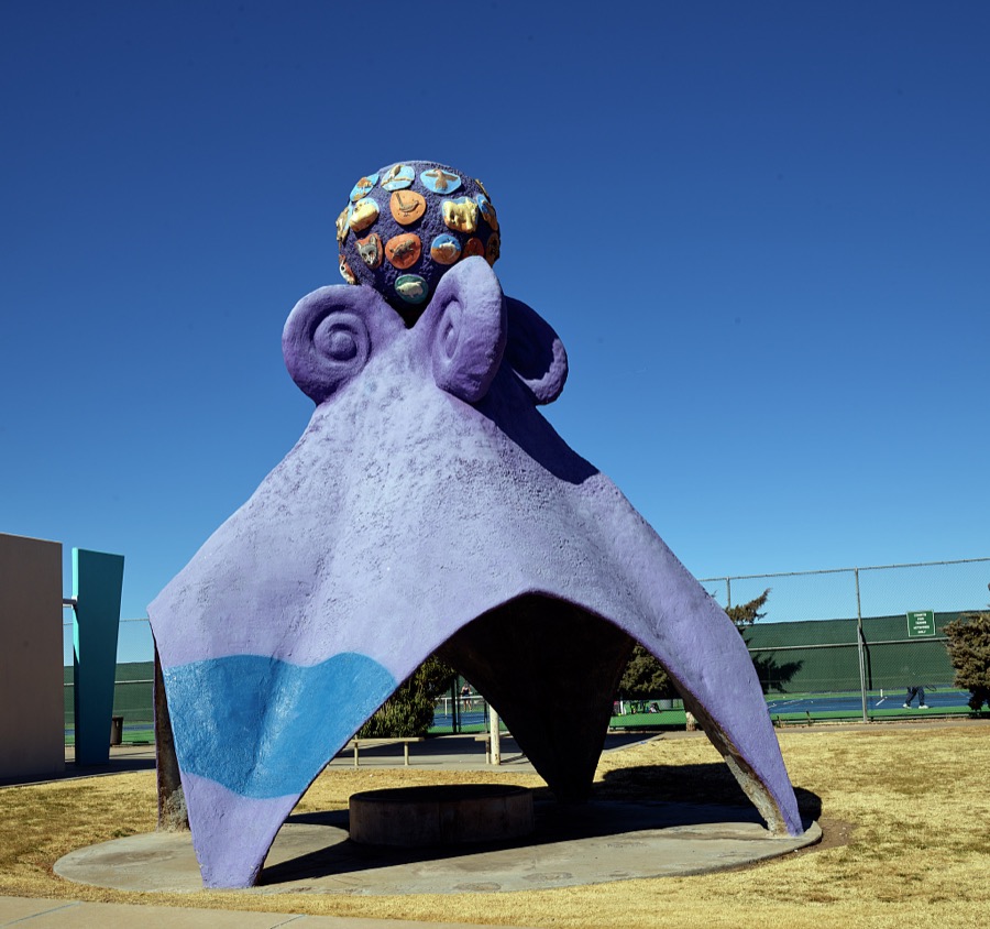 Artist Andrew Nagem's purple "thing," reminiscent of an octopus, which he named "Refuge," serves as a shady shelter and play area at the Laabs neighborhood park in Las Cruces, the hub city of southern New Mexico, 27 miles from the border with far-western Texas