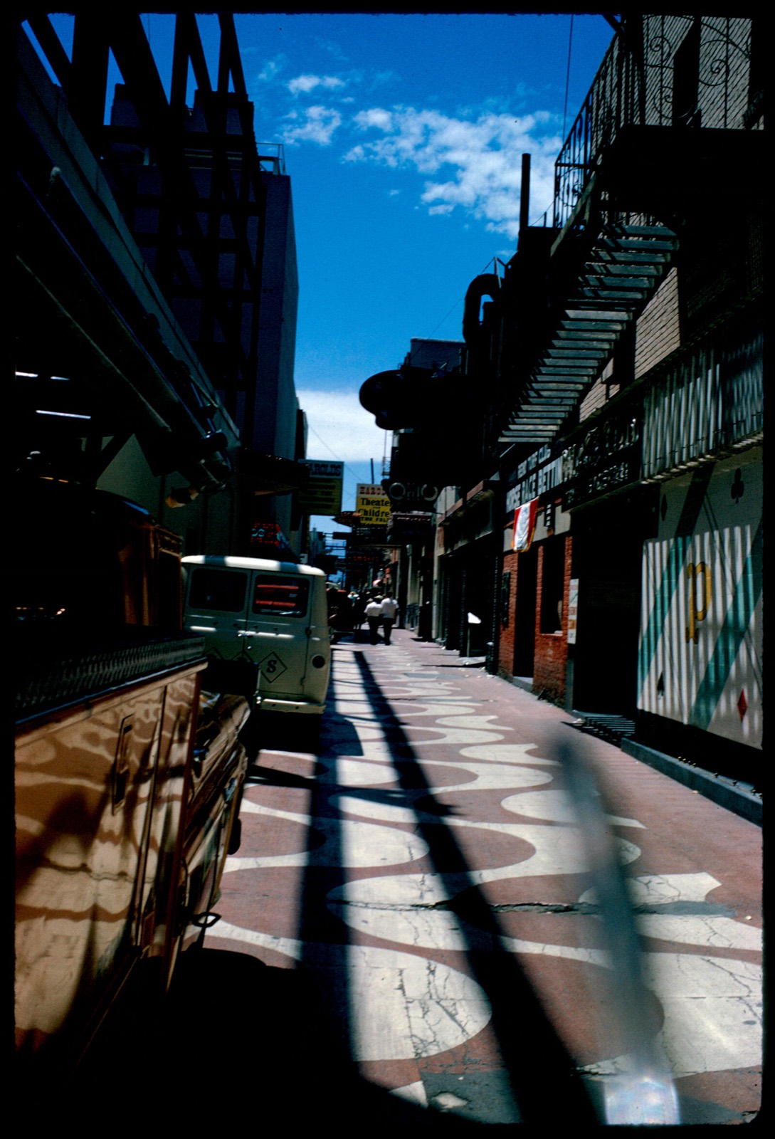 View down narrow street with signs including "Horse Race Betting," "Bank Cafe," and "Ohio," Reno, Nevada, Boston Public Library - undated