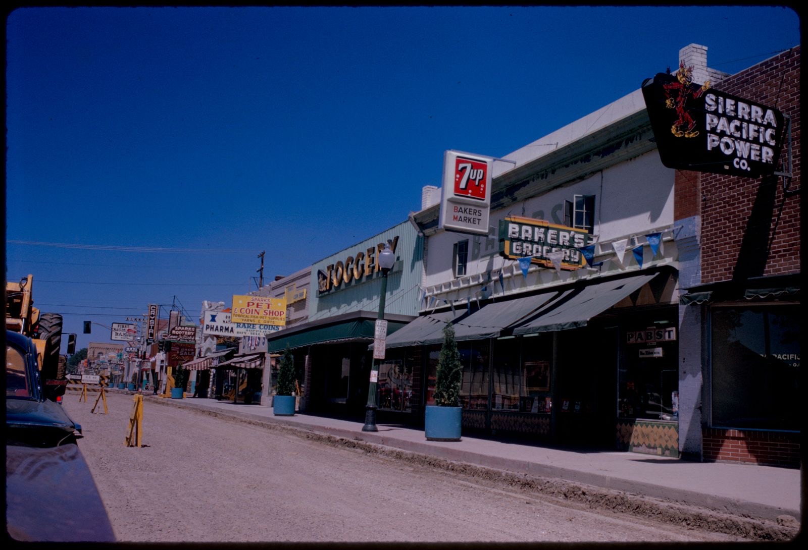 Row of shops including "Sierra Pacific Power Co." and "Baker's Grocery," Sparks, Nevada, Boston Public Library - undated
