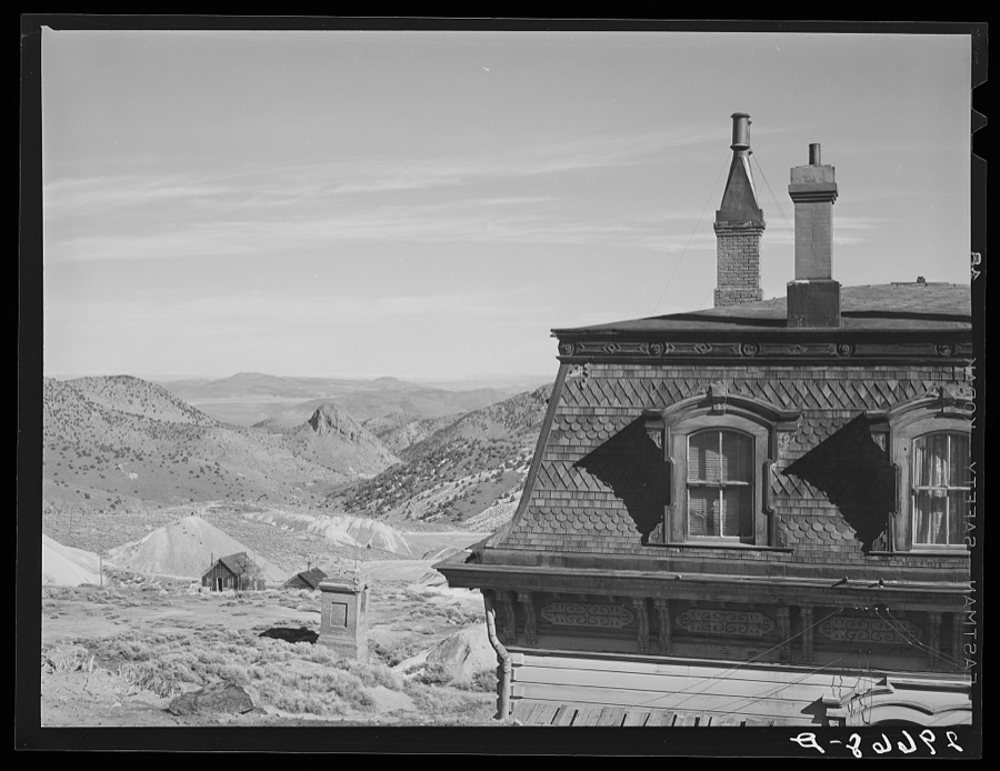 Corner of old mine office, abandoned mines in distance. Virginia City, Nevada