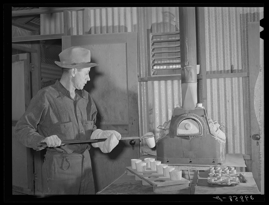 Assayer places crucible containing gold ore in furnace. El Dorado Canyon, Clark County, Nevada