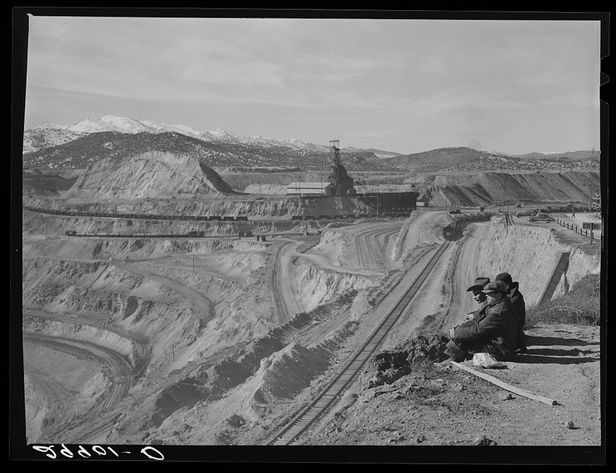 Workers sitting at edge of copper pit. Ruth, Nevada
