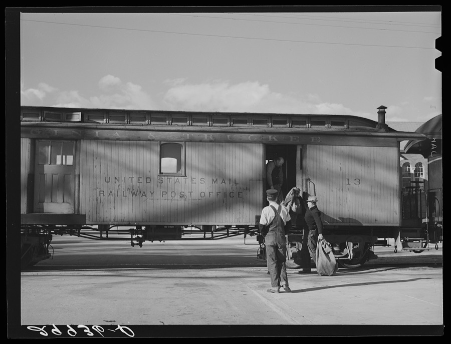 Loading mail into railroad car. Carson City, Nevada