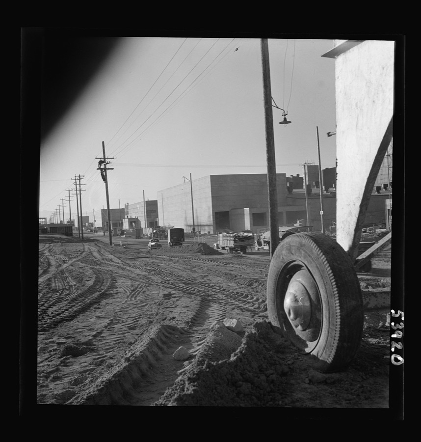 Las Vegas, Nevada. A view of the plant of Basic Magnesium Incorporated, showing unfinished roads, power lines, telephone lines on which two men are working, and buildings during an early stage of construction