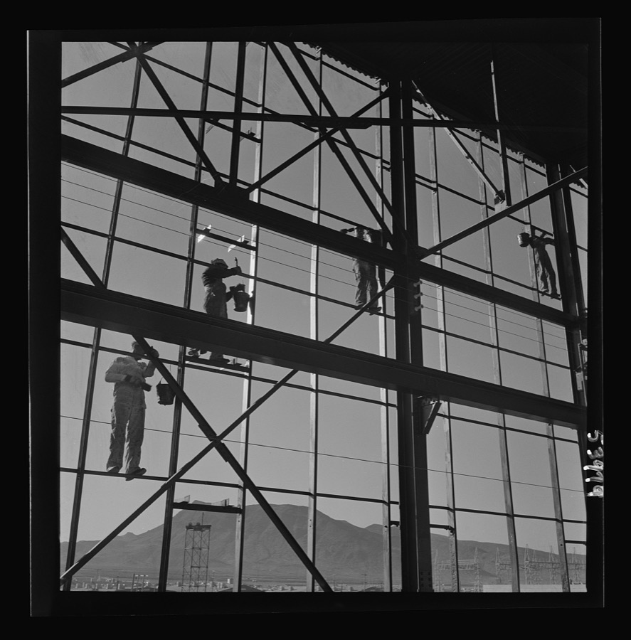Las Vegas, Nevada. Painters at work seventy feet above ground on the gigantic construction of the Basic Magnesium Incorporated plant in the southern Nevada desert. A tower of another building and mountain tops can be seen in the background