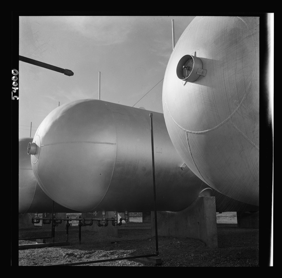Las Vegas, Nevada. Like a row of dirigible balloons, the propane gas storage tanks rest upon the floor of the southern Nevada desert at Basic Magnesium's giant plant, where magnesium is produced
