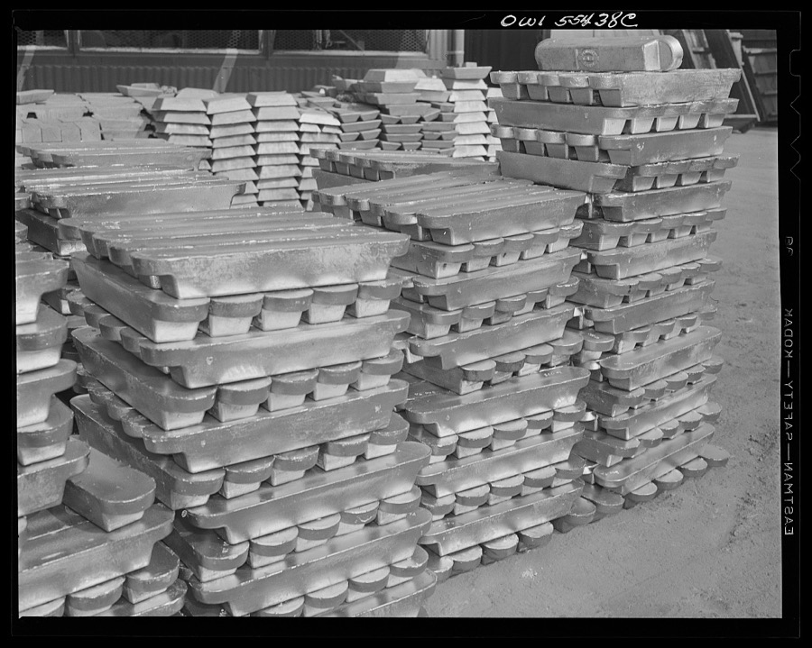 Las Vegas, Nevada. Enormous asbestos mittens are worn by the worker handling the hot magnesium ingots produced at the Basic Magnesium Incorporated plant in the southern Nevada desert