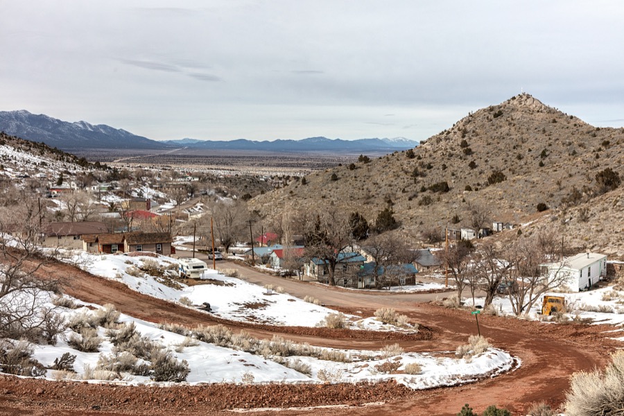 View from the hills above the old mining town of Pioche, which appears to hang along the side of a mountain and in a bowl below in Nevada's high desert, near the state's eastern border with Utah