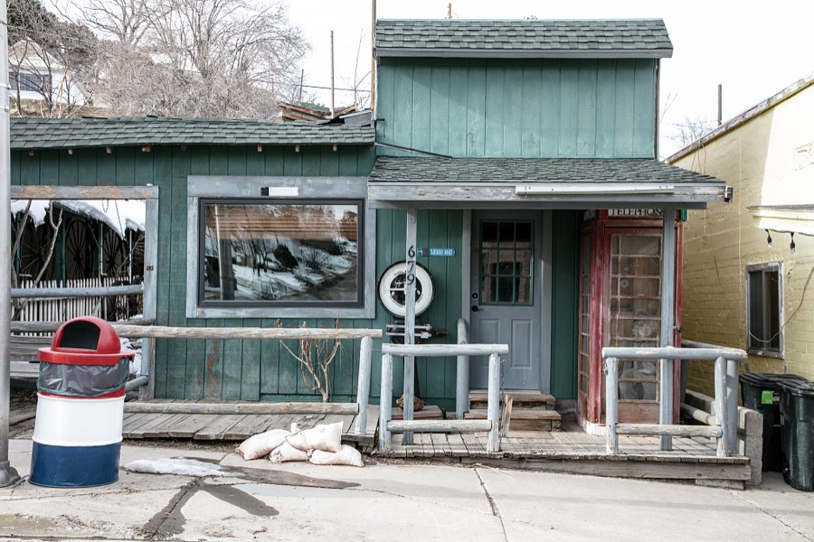 A shop and outdoor pay phone booth in the old mining town of Pioche, which appears to hang along the side of a mountain and in a bowl below in Nevada's high desert, near the state's eastern border with Utah