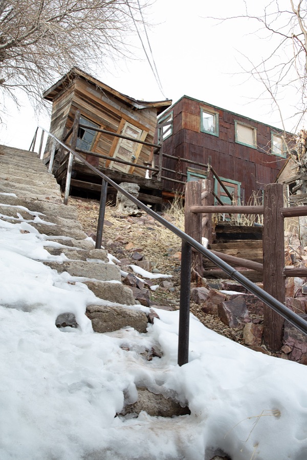 A (deliberately) crooked office building residence above the old mining town of Pioche, which appears to hang along the side of a mountain and in a bowl below in Nevada's high desert, near the state's eastern border with Utah