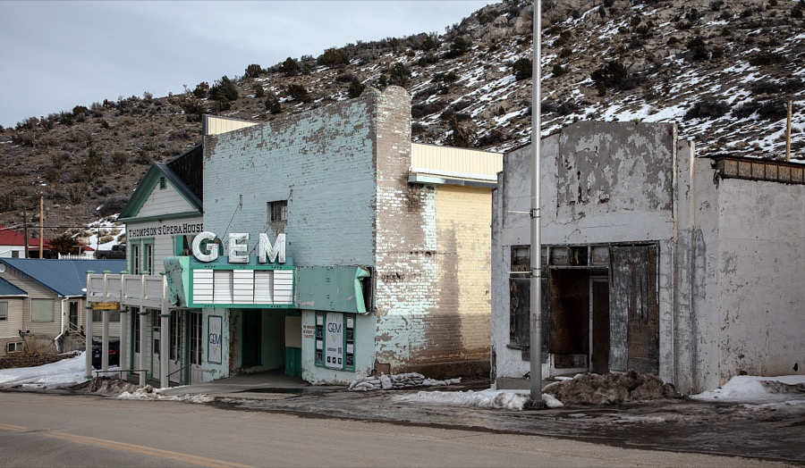 The abandoned Gem Theater, built in 1937 in the old mining town of Pioche, which appears to hang along the side of a mountain and in a bowl below in Nevada's high desert, near the state's eastern border with Utah