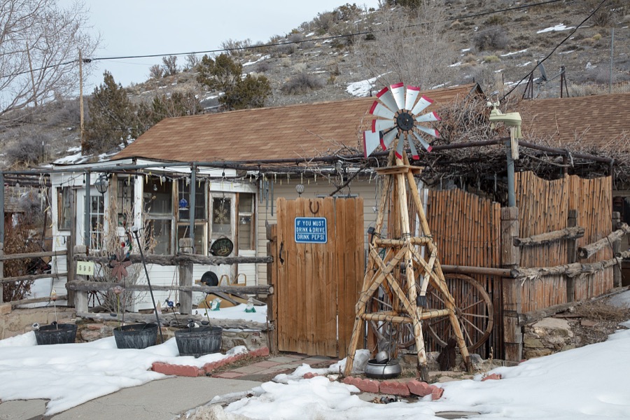 An old residence with a message in the old mining town of Pioche, which appears to hang along the side of a mountain and in a bowl below in Nevada's high desert, near the state's eastern border with Utah