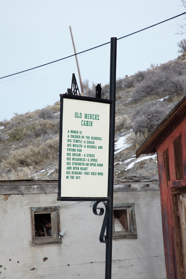 A sign saluting the onetime inhabitant of old miner's cabin in the mining town of Pioche, which appears to hang along the side of a mountain and in a bowl below in Nevada's high desert, near the state's eastern border with Utah