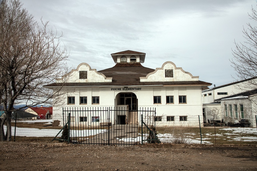 The historic Mission-style Pioche Grade School, which opened in 1909 in the old mining town of Pioche, which appears to hang along the side of a mountain and in a bowl below in Nevada's high desert, near the state's eastern border with Utah