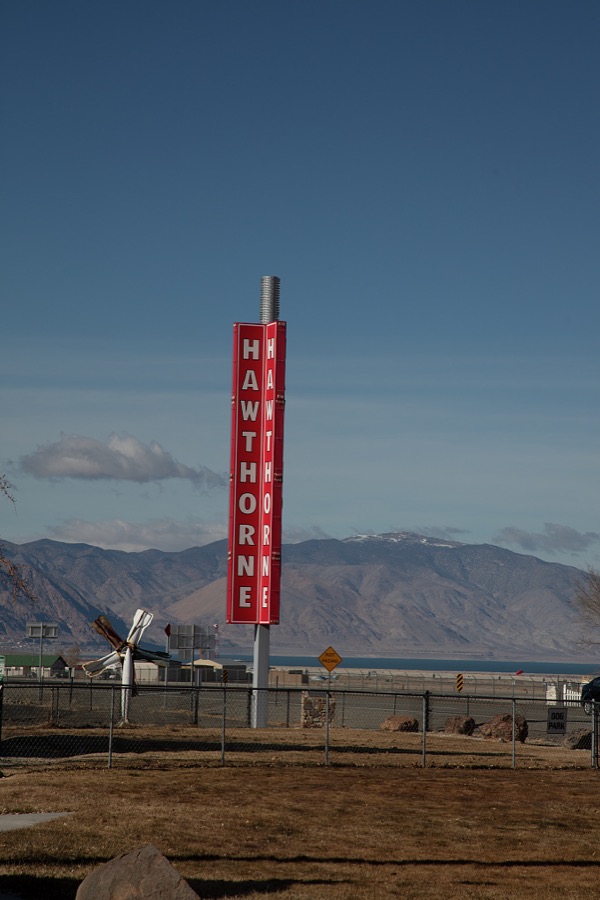 A bright sign announcing the town of Hawthorne in the remote western Nevada desert stands out from the area's bleak surroundings