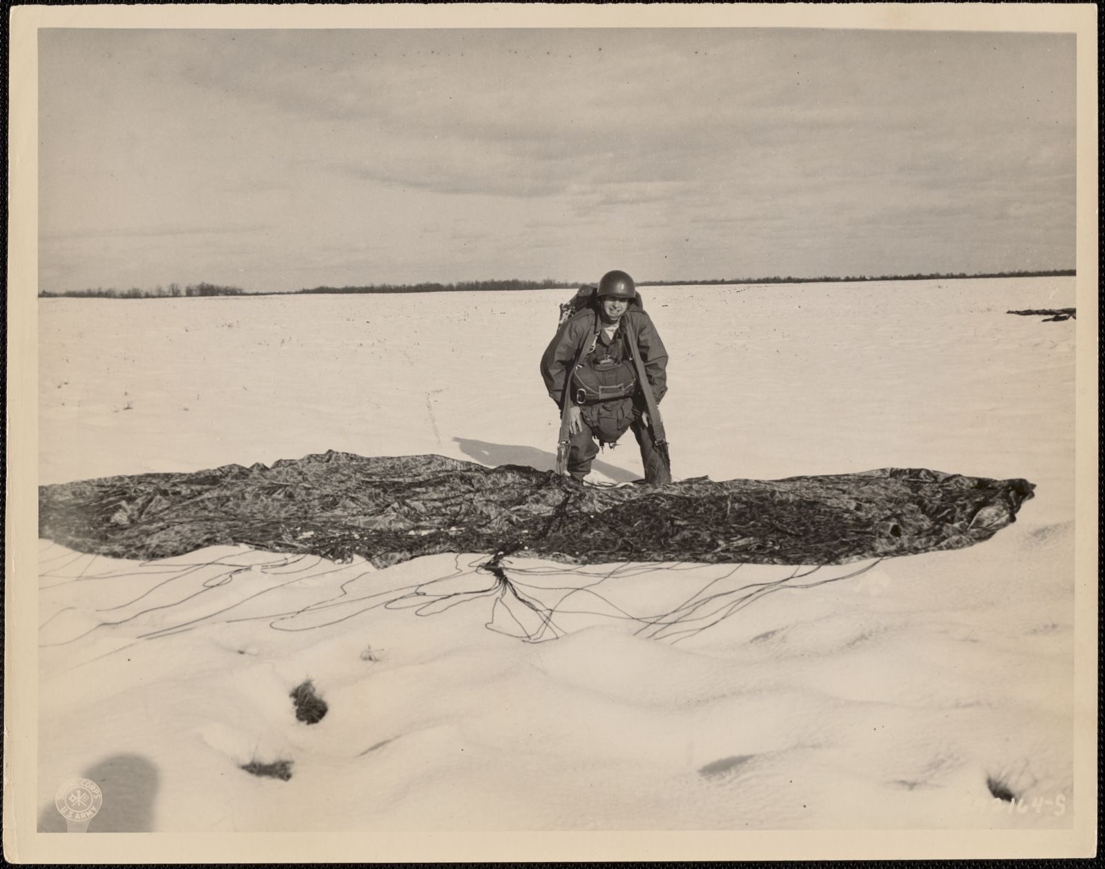 Second Lieutenant M. J. Dugan, jump master of the 505th Combat Team, rises to his feet after making a successful landing during the initial jump in "Exercise Snowdrop", American Legion Museum - undated