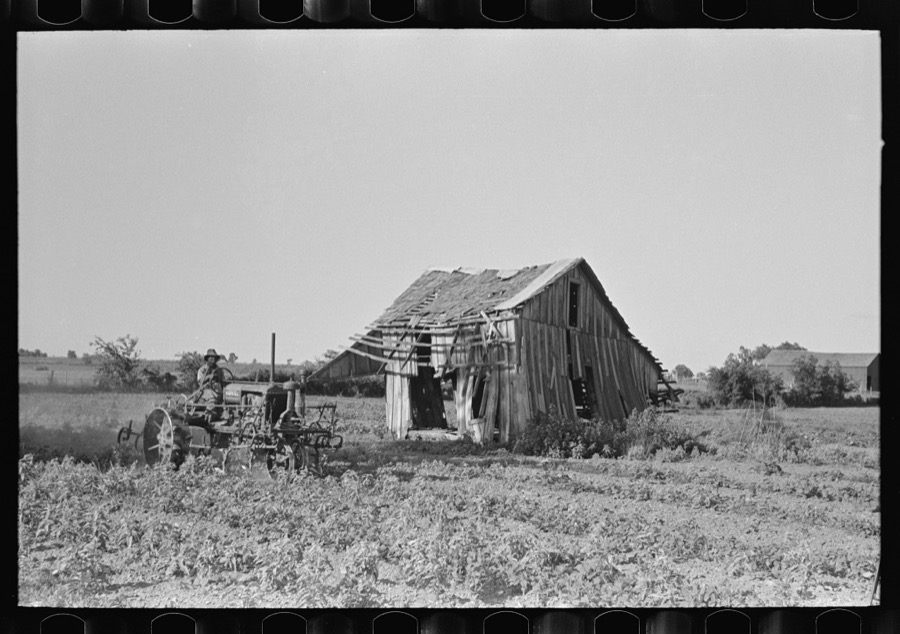 Tractor plowing near abandoned and wrecked tenant house, Wagoner County, Oklahoma