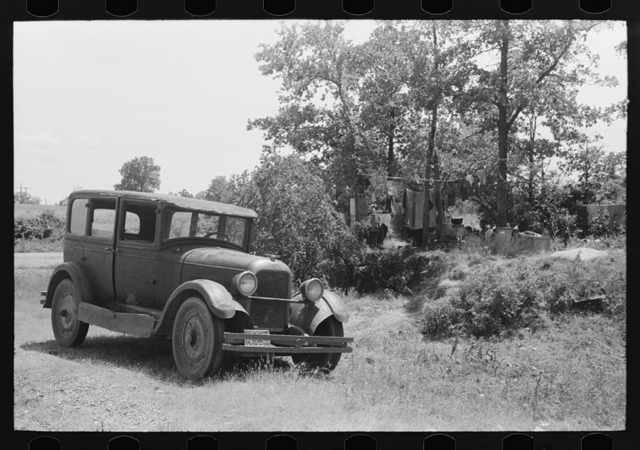 Automobile of family camped by the roadside while they did agricultural day labor in the neighborhood to secure funds to continue westward to Arizona and Califormia. This camp was near Spiro, Oklahoma