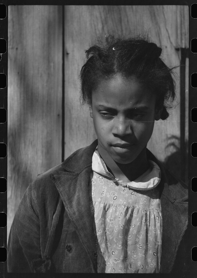 Oldest daughter of Pomp Hall, tenant farmer, with an ear of corn which she is shelling to feed her chickens, Creek County, Oklahoma. See general caption number 23